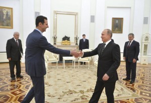 Russian President Putin shakes hands with Syrian President Assad during a meeting at the Kremlin in Moscow