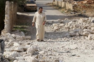 A man walks on the rubble of a damaged site hit by what activists said were air strikes carried out by the Russian air force on Reef al-Mohandeseen area in the western countryside of Aleppo, Syria