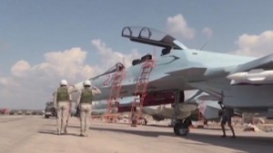 Frame grab shows pilots of the Russian air force saluting near a military jet before a sortie at the Hmeymim air base