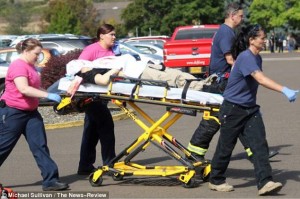 2CFCA59D00000578-3257645-Tragedy_A_victim_covered_in_a_bloody_blanket_is_seen_being_wheel-a-6_1443794237630