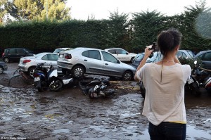 2D10FDAF00000578-3259269-Destructive_power_A_woman_inspects_damaged_cars_and_bikes_in_Man-a-73_1443955238491