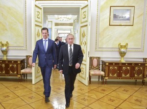 Russian President Putin and Syrian President Assad enter a hall during a meeting at the Kremlin in Moscow