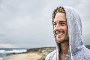 Caucasian man smiling on beach