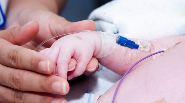 Newborn and hand